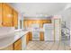 Bright kitchen featuring white appliances, light wood cabinets, and tile flooring at 814 Glenwood Dr, Lafayette, CO 80026