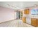 Eat in kitchen with tile floor, wooden cabinets and access to the rear yard at 814 Glenwood Dr, Lafayette, CO 80026