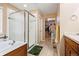 Bright bathroom with a glass-enclosed shower and adjacent walk-in closet with ample storage at 4814 Monarch Dr, Firestone, CO 80504