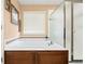 Bathroom featuring a large soaking tub with tile surround and a glass shower enclosure at 4814 Monarch Dr, Firestone, CO 80504