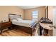 Relaxing bedroom features wood floors, a window with a view, and a dresser for storage at 4814 Monarch Dr, Firestone, CO 80504