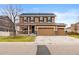 Charming two-story home featuring a three-car garage and a covered front porch at 4814 Monarch Dr, Firestone, CO 80504