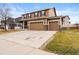 Charming two-story home with a three-car garage, a well-maintained lawn, and inviting curb appeal at 4814 Monarch Dr, Firestone, CO 80504