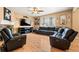 Comfortable living room with hardwood floors, a ceiling fan, and a large leather sectional at 4814 Monarch Dr, Firestone, CO 80504