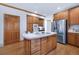 Well-equipped kitchen with an island, stainless steel appliances, and wood cabinetry at 19575 Misty Morning Dr, Monument, CO 80132