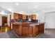 Basement wet bar has wooden cabinets, granite countertops, and wine storage at 19575 Misty Morning Dr, Monument, CO 80132