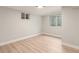 Basement bedroom with a light wood floor, white trim and walls, and a bright, modern ceiling light at 2655 Locust St, Denver, CO 80207