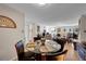 Dining area with glass-top table and four chairs, view of living room at 3164 S Wheeling Way # 306, Aurora, CO 80014