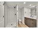 Recently updated bathroom offers a shower, wood-look flooring, and a modern vanity with great storage at 6485 S Havana St # A, Englewood, CO 80111