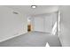 Bright bedroom features neutral carpet, fresh white paint, large windows, and a spacious closet at 6485 S Havana St # A, Englewood, CO 80111