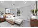 This is a bedroom with a bed, nightstands, and a large window at 6485 S Havana St # A, Englewood, CO 80111