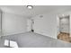 Open bedroom with large window features a neutral color palette with a carpeted floor and an adjacent bath at 6485 S Havana St # A, Englewood, CO 80111