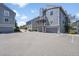 View of modern condo's exterior elevation highlighting private decks, garages, and parking spaces at 6485 S Havana St # A, Englewood, CO 80111