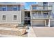 View of modern condo's exterior elevation highlighting private decks, garages, and beautiful stone landscaping at 6485 S Havana St # A, Englewood, CO 80111