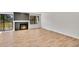 Spacious living room featuring wood flooring, fireplace, and large glass doors at 6485 S Havana St # A, Englewood, CO 80111