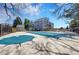 View of a fenced in, covered swimming pool in the community with blue sky and mature trees in the background at 6485 S Havana St # A, Englewood, CO 80111