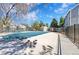 Community pool in the off-season with a safety fence and view of mature trees and other community buildings at 6485 S Havana St # A, Englewood, CO 80111