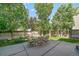 Backyard view showcasing a spacious patio set with an outdoor dining table, perfect for entertaining guests at 10610 Winterflower Way, Parker, CO 80134