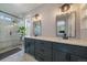Dual sink vanity with marble countertops and tile flooring and a glass enclosed shower at 10610 Winterflower Way, Parker, CO 80134