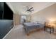 Spacious bedroom with a ceiling fan, neutral carpet, and black accent wall at 10610 Winterflower Way, Parker, CO 80134