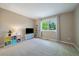 Cozy bedroom with large window, plush carpet, wall-mounted television, and ample space for play or relaxation at 10610 Winterflower Way, Parker, CO 80134