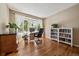 Bright home office with hardwood floors, a large bay window, and built-in bookshelves at 10610 Winterflower Way, Parker, CO 80134
