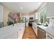 Bright kitchen with white cabinetry, stainless appliances, and a large island with marble countertops at 10610 Winterflower Way, Parker, CO 80134