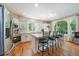 Bright kitchen with white cabinetry, stainless appliances, and a large island with bar seating at 10610 Winterflower Way, Parker, CO 80134