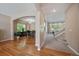 Spacious living room featuring hardwood floors, arched doorways, staircase, and filled with natural light at 10610 Winterflower Way, Parker, CO 80134