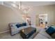 Open living room featuring a staircase, a view into the kitchen, and plenty of natural light at 10610 Winterflower Way, Parker, CO 80134