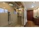 Bathroom featuring a glass enclosed shower, double vanity, and wooden cabinets at 10645 Routt St, Westminster, CO 80021