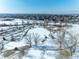 Stunning aerial view of a snow-covered community park with walking trails, trees, and open spaces on a bright winter day at 10902 Bannock St, Northglenn, CO 80234