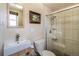 Bathroom featuring a modern sink, toilet, and shower with tiled walls and glass door at 10902 Bannock St, Northglenn, CO 80234