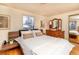 Inviting bedroom with natural light, hardwood floors, a comfortable bed, and ample space at 10902 Bannock St, Northglenn, CO 80234