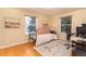 Cozy bedroom setup with wood floors and large windows providing plenty of natural light at 10902 Bannock St, Northglenn, CO 80234