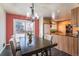Bright dining room with a chandelier, access to the backyard, and an open flow to the kitchen space at 10902 Bannock St, Northglenn, CO 80234