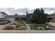 Charming brick home featuring a landscaped front yard, brick walkway, and attached garage at 10902 Bannock St, Northglenn, CO 80234