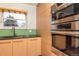 Contemporary kitchen featuring stainless steel appliances, natural wood cabinets, and a sleek design for modern cooking at 10902 Bannock St, Northglenn, CO 80234