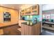 Modern kitchen featuring custom wood cabinets, marble countertops, and stainless steel appliances with open access to the living room at 10902 Bannock St, Northglenn, CO 80234