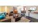 Comfortable living room with a sofa, stylish rug, and ample natural light leading to dining room at 10902 Bannock St, Northglenn, CO 80234