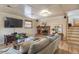 Cozy living room featuring a brick fireplace, wood floors, and a comfortable seating area at 10902 Bannock St, Northglenn, CO 80234