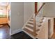 View of the staircase featuring hardwood steps, white risers, and a wooden handrail at 10902 Bannock St, Northglenn, CO 80234