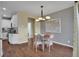 Cozy dining area with a modern light fixture and views into the kitchen at 14200 Lakeview Ln, Broomfield, CO 80023