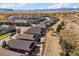 Expansive aerial view of a neighborhood with mature trees and a mountain range in the background at 14921 W 70Th Ave, Arvada, CO 80007