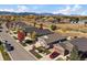 Scenic aerial view of homes in a neighborhood featuring fall foliage and mountain views at 14921 W 70Th Ave, Arvada, CO 80007