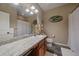 Bright bathroom featuring a vanity with granite countertops, a large mirror, and stylish decor at 14921 W 70Th Ave, Arvada, CO 80007