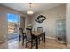 Bright dining area with a view of the backyard through sliding glass doors and a modern light fixture at 14921 W 70Th Ave, Arvada, CO 80007