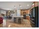 A well-lit kitchen with wood cabinets, stainless steel appliances, and seating at the island at 14921 W 70Th Ave, Arvada, CO 80007