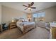 A bright main bedroom featuring natural light and a ceiling fan at 14921 W 70Th Ave, Arvada, CO 80007