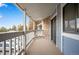 Spacious outdoor balcony featuring white railing and carpet with a view of the parking lot at 8335 Fairmount Dr # 9-206, Denver, CO 80247